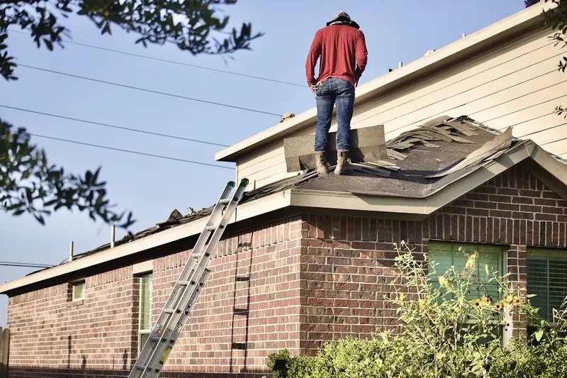 Professional roofer working on a residential roof in Pratts Corner